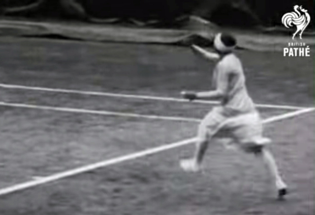 A black and white screenshot showing a woman playing tennis