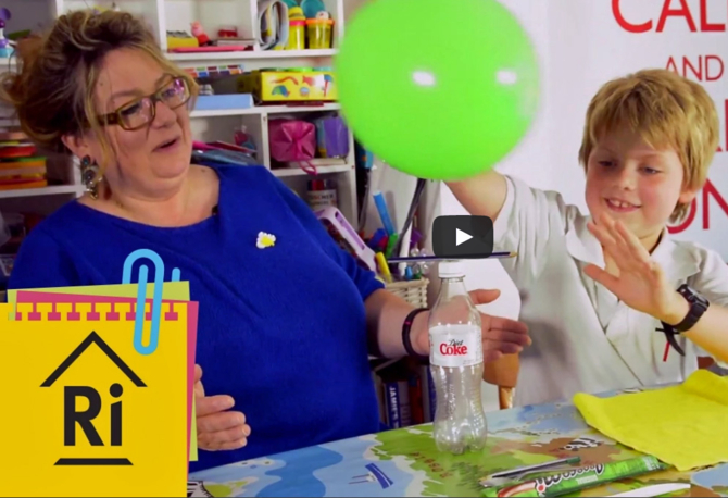 A mother and son playing with a balloon