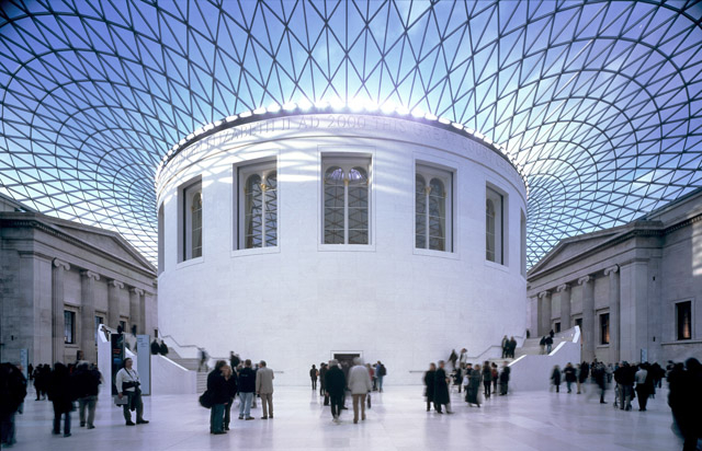 An enclosed courtyard with a glass roof and a round building in the centre