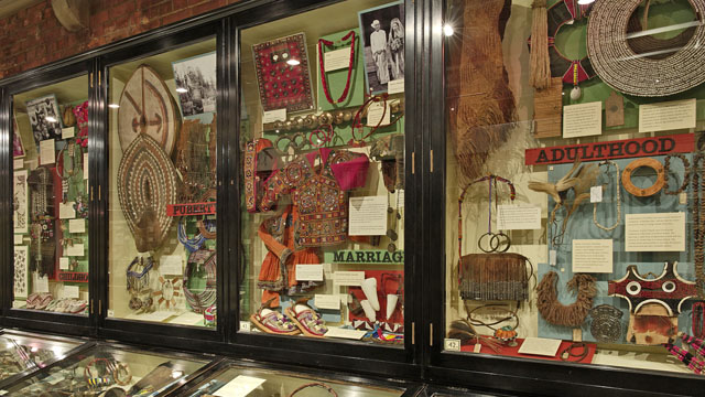 wooden museum cases showing many ethnographic objects relating two different stages of life